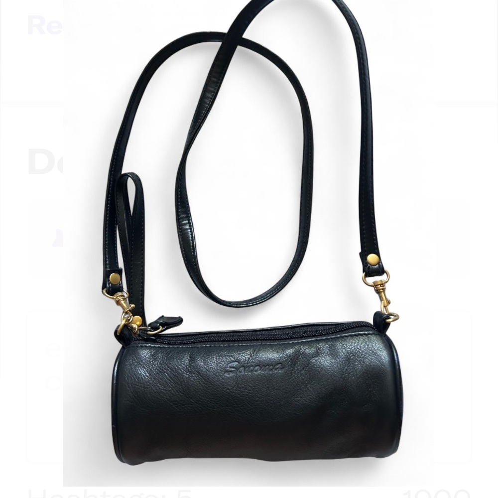 Sanoma black cylinder-shaped purse with removable strap.